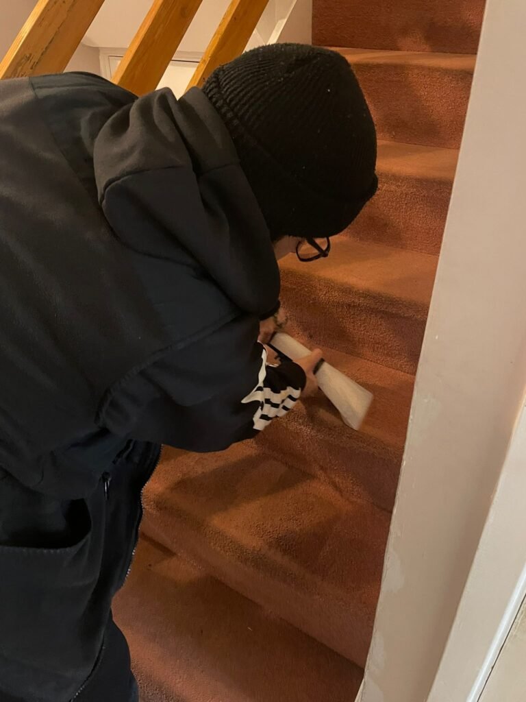 Merlin's technician cleaning stair carpet